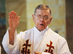 Retired Father Henry Brown prays the eucharistic prayer during a May 11, 2006, Mass at St. Paul Hermitage in Beech Grove. Father Brown, who died on June 21, 2009, became a resident at the Hermitage in 1998, and soon became known for his tireless ministry to his fellow residents who were close to death. (File photo by Sean Gallagher)