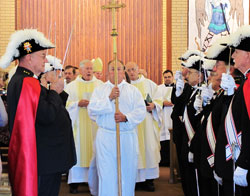 Members of the Knights of Columbus stand at attention during the closing procession of a Sept. 12 Mass at St. Michael Church in Charlestown to celebrate the parish’s 150th anniversary. Archbishop Daniel M. Buechlein was the principal celebrant at the Mass. (Photo by Sean Gallagher)