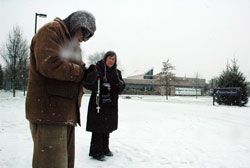 Bob Rust, left, and Margie Schmitz pray the rosary on Jan. 7 outside a Planned Parenthood abortion center in Indianapolis. The sidewalk counselors offer information and help to mothers considering abortion. Rust is a member of St. John the Evangelist Parish in Enochsburg. Schmitz is a member of St. Luke the Evangelist Parish in Indianapolis. (Photo by Sean Gallagher)