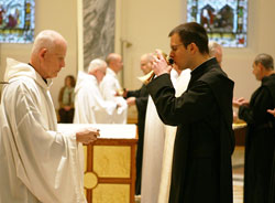 Benedictine Brother Mauritius Honegger, right, drinks from a chalice given to him by Benedictine Father Germain Swisshelm during a May 6 Mass in the Archabbey Church of Our Lady of Einsiedeln in St. Meinrad. Brother Mauritius, a member of Einsiedeln Abbey in Switzerland, is a former member of the Vatican’s Swiss Guard, and spent the past academic year as a student at Saint Meinrad Seminary and School of Theology in St. Meinrad. (Photo courtesy of Saint Meinrad Archabbey)