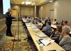 Father Patrick Beidelman, left, director of liturgy in the archdiocese’s Office of Worship, speaks on Aug. 2 to directors of religious education, principals and youth ministers from across the archdiocese at the French Lick Resort in French Lick, Ind., about Masses with children. The workshop took place during the annual administrators’ conference sponsored by the archdiocese’s Office of Catholic Education. (Photo by Sean Gallagher)