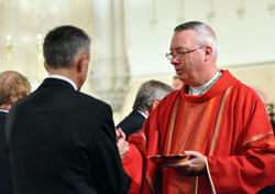 Bishop Christopher J. Coyne, apostolic administrator, gives Communion to a member of the St. Thomas More Society during the legal organization’s annual Red Mass on Oct. 3 at St. John the Evangelist Church in Indianapolis. (Photo by Mary Ann Garber)