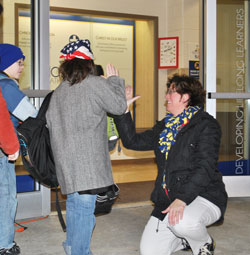 Known for her upbeat, dynamic approach to Catholic education, Gina Fleming is a new assistant superintendent of schools for the archdiocese. Here, she greets a student with a high-five during her six years as principal of Holy Name School in Beech Grove. (Submitted photo)