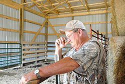 Fred Burns stands inside one of the two small barns built for him through money donated by Mercury One and distributed by Catholic Charities of the Archdiocese of Indianapolis. (Photo by Natalie Hoefer)