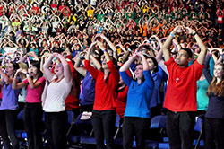 At the opening session of the National Catholic Youth Conference in Indianapolis on Nov. 21, 23,000 participants sing and move to a song in Lucas Oil Stadium. (Photo by Natalie Hoefer)