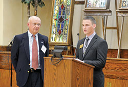 Joe Huelseman, right, an archdiocesan seminarian at Bishop Simon Bruté College Seminary in Indianapolis, reads a letter of thanks to donor Art Berkemeier of St. Mark the Evangelist Parish in Indianapolis during a Circle of Giving event at the Archbishop Edward T. O’Meara Catholic Center on May 4. (Photo by Natalie Hoefer)