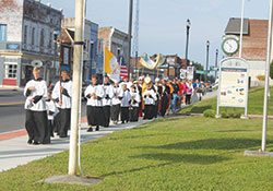 Altar servers lead the way in an Aug. 27 eucharistic procession of members of Annunciation Parish in Brazil through the streets of the west central Indiana town from its temporary worship space to its restored church. (Submitted photo by Shayna Tews)