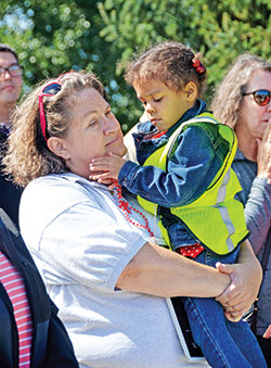 During a 40 Days for Life rally at the Planned Parenthood abortion facility in Indianapolis on Sept. 26, Linda Kile holds Larelle Thompson, whose life she helped save from abortion at the same facility three-and-a-half years ago. (Photo by Natalie Hoefer)