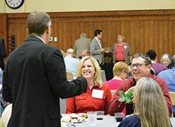 Marcie and Tom Renken of Our Lady of the Greenwood Parish in Greenwood share a laugh with Archbishop Charles C. Thompson during a gathering of Miter Society members at the Archbishop Edward T. O’Meara Catholic Center in Indianapolis on Oct. 10. (Photo by Natalie Hoefer)