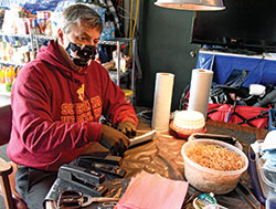 Jim Donlan, a member of Holy Spirit Parish in Indianapolis, assembles a mask on April 9 in the garage of his home on the east side of Indianapolis. In less than three weeks, Donlan and volunteers who have come to his home have made and given away some 2,800 masks that can be used to help stop the spread of the coronavirus. (Photo by Sean Gallagher) 