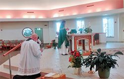 Father Jeffrey Moore celebrates Mass for St. Cuthbert of Lindisfarne Parish of the Ordinariate of the Chair of St. Peter, which worships at Good Shepherd Church in Indianapolis. Assisting him at left is Lee Ashton, a deacon candidate for the ordinariate. (Submitted photo)