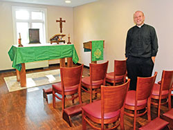 Father Andrew Syberg stands on Aug. 1 in a new chapel for first-year seminarians at Bishop Simon Bruté College Seminary in Indianapolis. (Photo by Sean Gallagher)