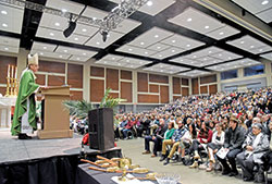 Archbishop Charles C. Thompson preaches a homily on Jan. 21 at the Lawrenceburg Event Center in Lawrenceburg during a Mass to celebrate 200 years of Catholicism in Dearborn County. Some 1,500 Catholics from across the county in southeastern Indiana took part in the liturgy. (Photo by Sean Gallagher)