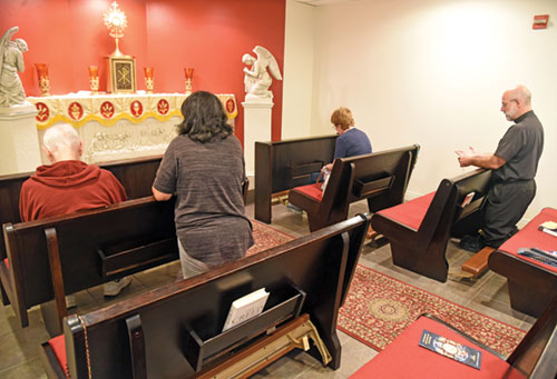 Father Todd Goodson, right, leads a holy hour for vocations on Oct. 4 in the adoration chapel of Our Lady of the Greenwood Parish in Greenwood. (Photo by Sean Gallagher)