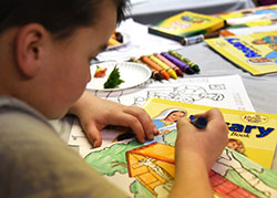 Holy Name parishioner Henry "Hank" Walkowiak, 9, colors religious-themed art at the Cedar Lake parish's 24 Hours with Christ initiative on March 4. Youngsters participated in supervised activities while most adults prayed in the church. (Anthony D. Alonzo photo)