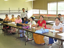 Photo caption: Students are shown at the job readiness classes at the former St. Henry School. The classes instruct the Burmese refugees on a variety of topics, such as how to apply for a job and appropriately answer the phone. Catholic Charities staff even conduct mock interviews to help them prepare. (Photo by Lauren Caggiano) 